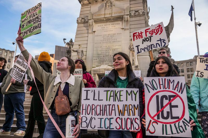 IU Indy student Lillian Ray and Marian University students Sienna Mullen and Leila Ramirez-Noon stand Friday, Feb. 13, 2026, during a protest against ICE around Monument Circle in Indianapolis. About 100 people marched.