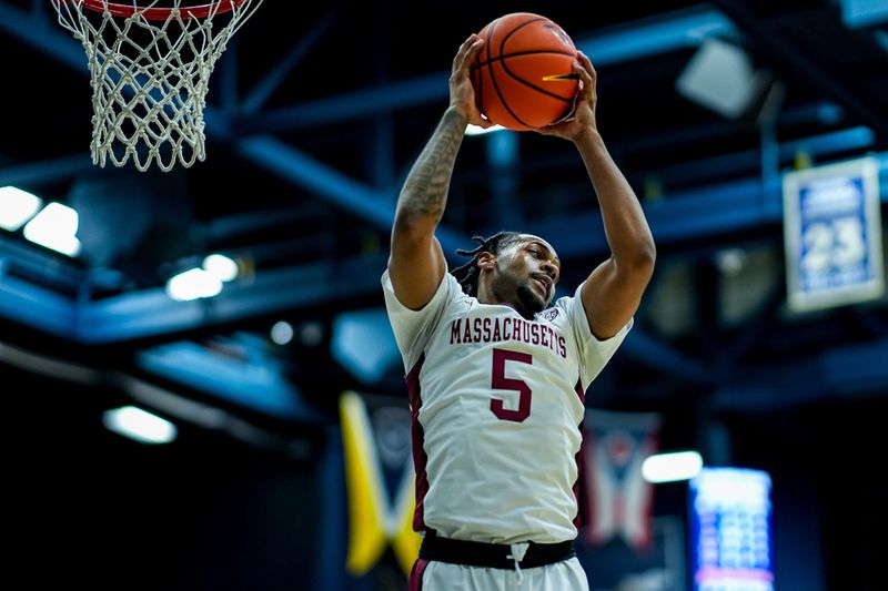 UMass’s K'Jei Parker (5) grabs a rebound in a game against Akron, Feb. 13, 2026, at James A Rhodes Arena in Akron, Ohio.