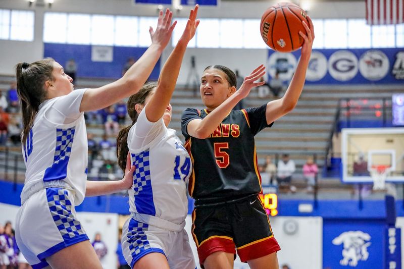 McCutcheon's Keara Lipscomb-Allen whips an overhead pass over two Hamilton Southeastern defenders during the second half of the IHSAA regional matchup between HSE and McCutcheon on Feb. 14, 2026 at the Everett N. Case Arena in Frankfort, IN.