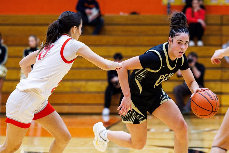 Penn's Jillian Sanderson drives with the ball as Crown Point's Amiyah Menchaca defends during the Penn-Crown Point high school 4A regional basketball game on Saturday, February 14, 2026, at LaPorte High School in LaPorte, Indiana.