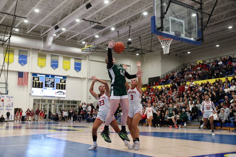 Pendleton Heights forward Adah Hupfer (50) jumps up to catch a pass on Saturday, Feb. 14, 2026, during a regional matchup between Center Grove and Pendleton Heights at Greenfield-Central High School in Greenfield, Ind.