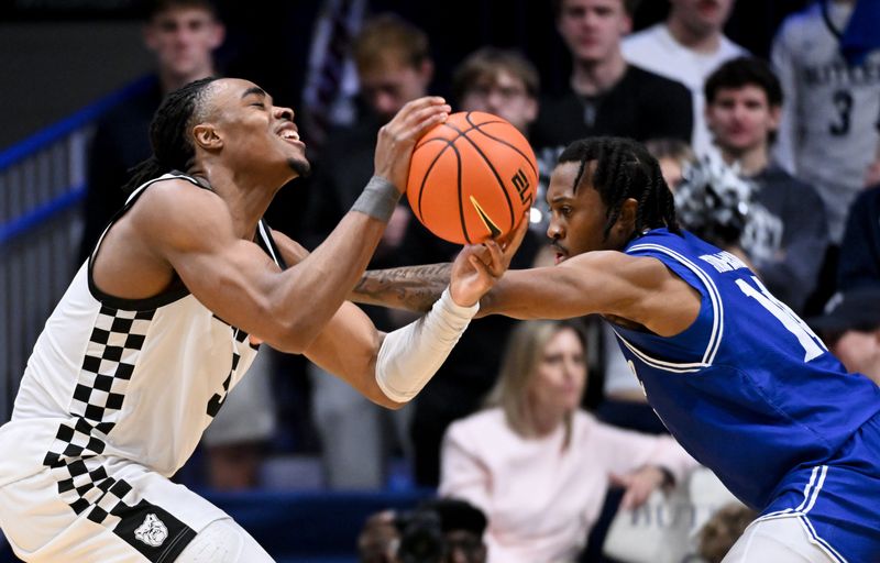 Feb 15, 2026; Indianapolis, Indiana, USA; Seton Hall Pirates guard AJ Staton-McCray (14) fouls Butler Bulldogs forward Michael Ajayi (5) during the first half at Hinkle Fieldhouse. Mandatory Credit: Robert Goddin-Imagn Images