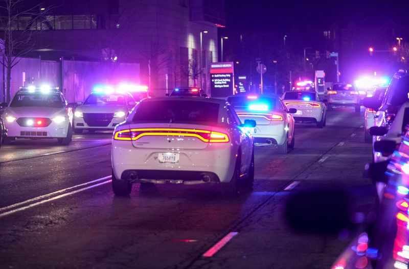 A procession of police cars follow an ambulance after Brian Elliott, 33, a Beech Grove police officer, was killed Monday, Feb. 16, 2026, outside Sidney & Lois Eskenazi Hospital in Indianapolis.