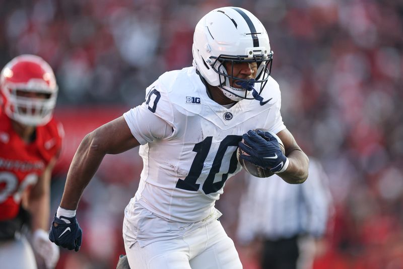 Penn State Nittany Lions running back Nicholas Singleton carries the ball against the Rutgers Scarlet Knights.