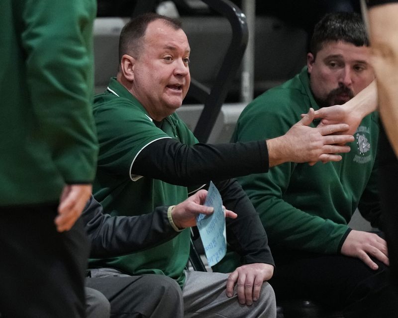 Monrovia Bulldogs head coach Brian Barber high-fives a player on Tuesday, Feb. 17, 2026, during the game at Monrovia High School in Monrovia.