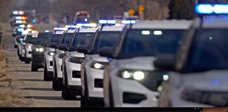 A long procession of vehicles move along Keystone Parkway Wednesday, Feb. 18, 2026 as they transport fallen Beech Grove Police Officer Brian Elliott from the Marion County Coroner’s Office to the funeral home.