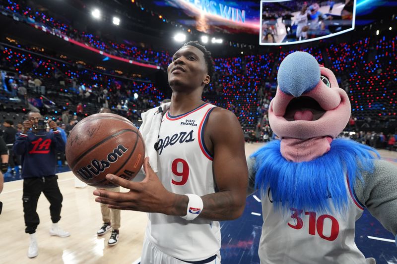 Feb 19, 2026; Inglewood, California, USA; LA Clippers guard Bennedict Mathurin (9) with Clippers mascot Chuck the Condor after the game against the Denver Nuggets at Intuit Dome.
