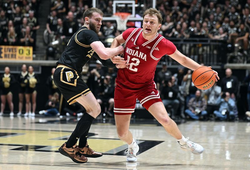 Feb 20, 2026; West Lafayette, Indiana, USA; Indiana Hoosiers forward Tucker Devries (12) is fouled by Purdue Boilermakers guard Braden Smith (3) during the first half at Mackey Arena. Mandatory Credit: Marc Lebryk-Imagn Images
