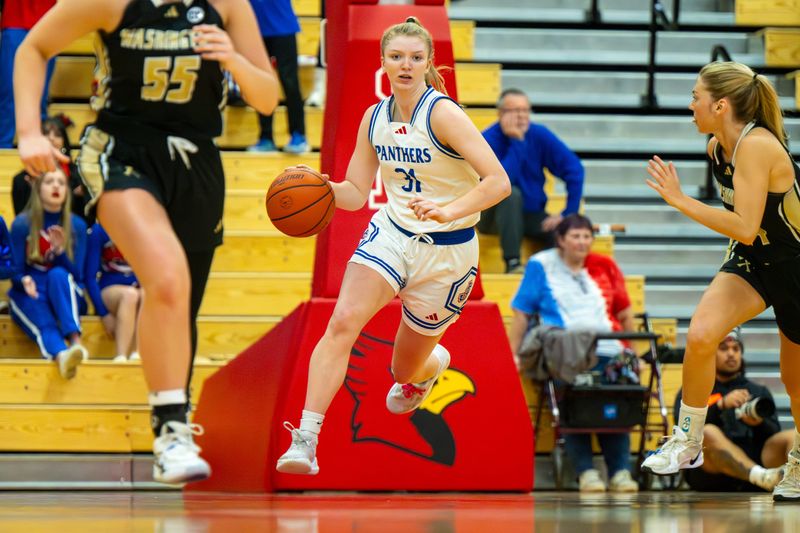 Jennings County High School senior Mollie Ernstes (31) brings the ball up court during the first half of an IHSAA Class 3A girls basketball semi-state semifinal game against Washington High School, Saturday, Feb. 21, 2026, at Southport Fieldhouse in Indianapolis.