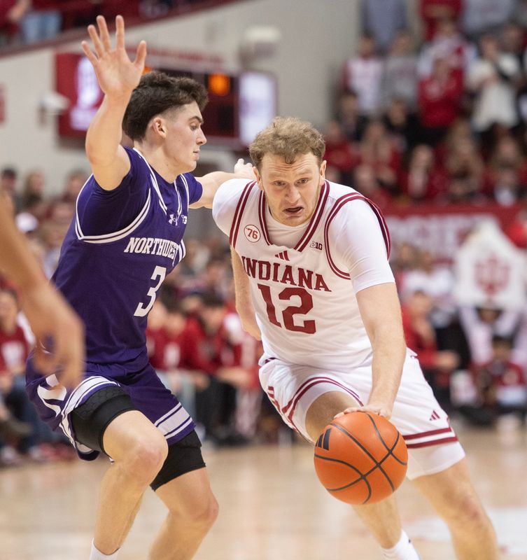 Indiana's Tucker DeVries (12) drives on Northwestern's Jake West (3) during the Indiana versus Northwestern men's basketball game at Simon Skjodt Assembly Hall on Tuesday, Feb. 24, 2026.