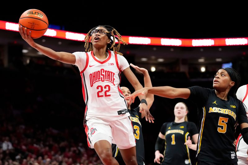 Ohio State Buckeyes guard Jaloni Cambridge (22) shoots past Michigan Wolverines guard Brooke Q. Daniels (5) during the NCAA women's basketball game at the Jerome Schottenstein Center on Feb. 25, 2026. Ohio State lost 88-86 in overtime.