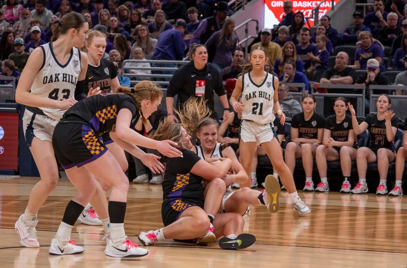 Players wrestle for a loose ball in the third quarter at the IHSSA Class 2A girls basketball state finals Eastern faced Oak Hill Saturday, Feb. 28, 2026, at the Gainbridge Fieldhouse in Indianapolis. Eastern defeated Oak Hill 50 to 32.