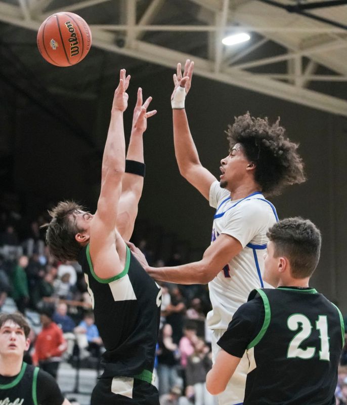 Hamilton Southeastern Royals Varschon Clark (24) passes over Westfield Shamrocks Wyatt Freehauf (23) on Tuesday, March 3, 2026, during an IHSAA boys basketball sectionals matchup at Noblesville High School in Noblesville, Ind.