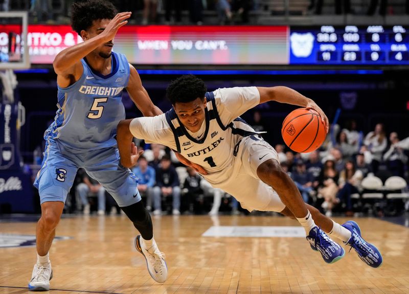 Butler Bulldogs guard Evan Haywood (1) slips while rushing up the court against Creighton Bluejays guard Nik Graves (5) on Wednesday, March 4, 2026, during the game at Hinkle Fieldhouse in Indianapolis.