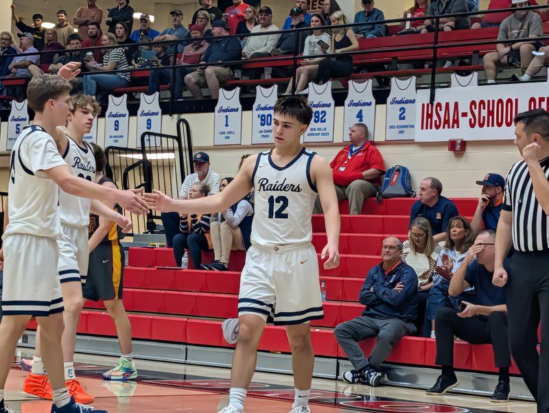 Harrison guard Brody Baker (right) high fives senior Quinn Clary (front left) and Xavier Fidago (back left) after a defensive stop during the fourth quarter of the IHSAA class 4A sectional semifinals against McCutcheon in Lafayette, Indiana on Friday, March 6, 2026.