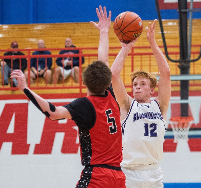 South's Max Surdam (12) shoots a three-pointer over Terre Haute South's Austin Semmler (5) during the Bloomington South versus Terre Haute South IHSAA sectional boy's basketball game at Martinsville High School on Friday, March 6, 2026.