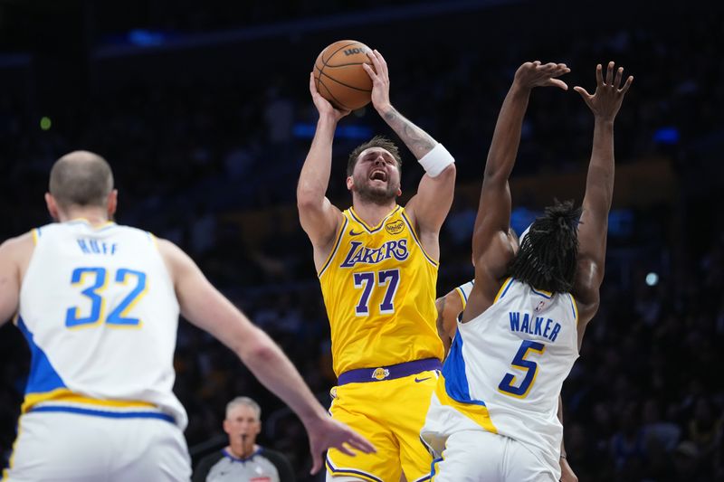 Mar 6, 2026; Los Angeles, California, USA; Los Angeles Lakers guard Luka Doncic (77) shoots the ball against Indiana Pacers forward Jarace Walker (5) and center Jay Huff (32) in the first half at Crypto.com Arena. Mandatory Credit: Kirby Lee-Imagn Images
