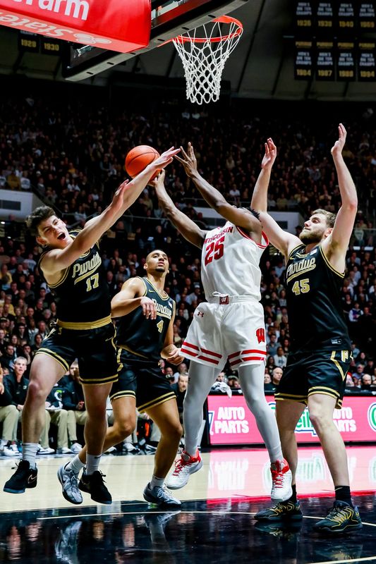 Omer Mayer and Oscar Cluff defend a layup by Wisonsin's John Blackwell during the first half of Purdue's game against Wisconsin on Mar. 7, 2026, at Mackey Arena in West Lafayette, IN.