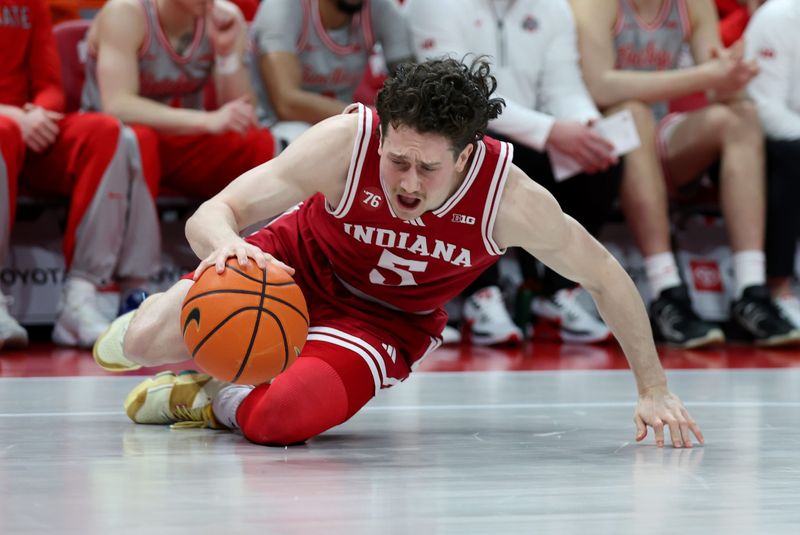 Mar 7, 2026; Columbus, Ohio, USA; Indiana Hoosiers forward Conor Enright goes to the floor for a loose ball during the first half against the Ohio State Buckeyes at Value City Arena. Mandatory Credit: Joseph Maiorana-Imagn Images