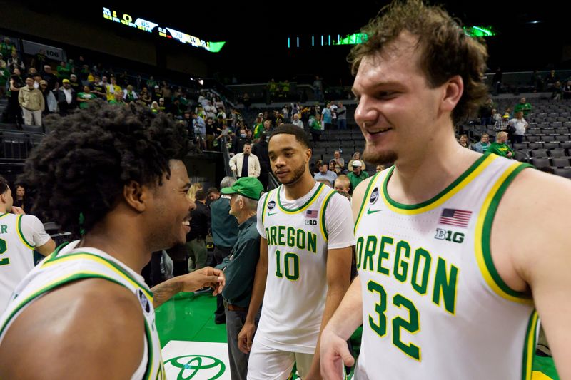 From left, Oregon guard Takai Simpkins, forward Kwame Evans Jr. and center Nate Bittle celebrate their win as the Oregon Ducks host the Washington Huskies on March 7, 2026, at Matthew Knight Arena in Eugene, Oregon.