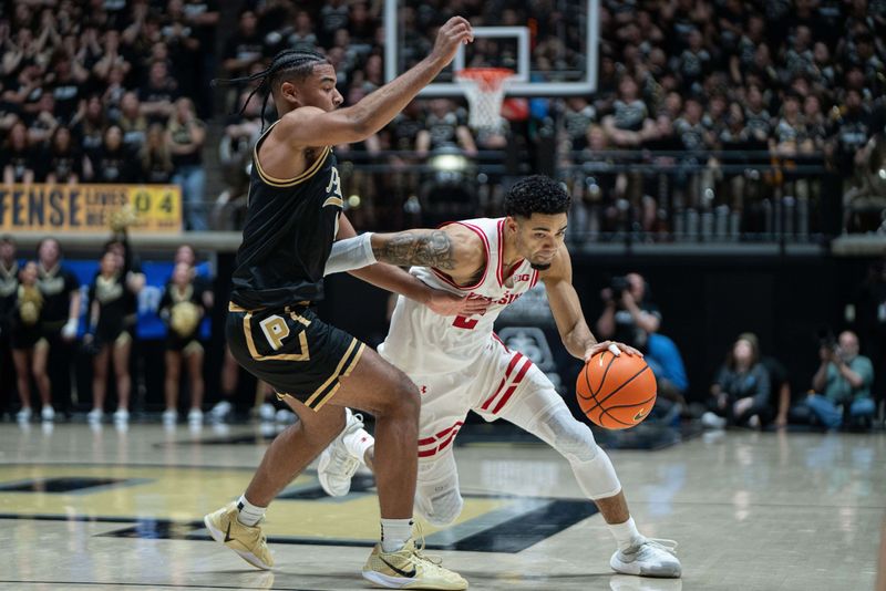 Mar 7, 2026; West Lafayette, Indiana, USA; Wisconsin Badgers guard Nick Boyd (2) drives to the basket around Purdue Boilermakers guard C.J. Cox (0) during the first half against the Purdue Boilermakers at Mackey Arena. Mandatory Credit: Jacob Musselman-Imagn Images