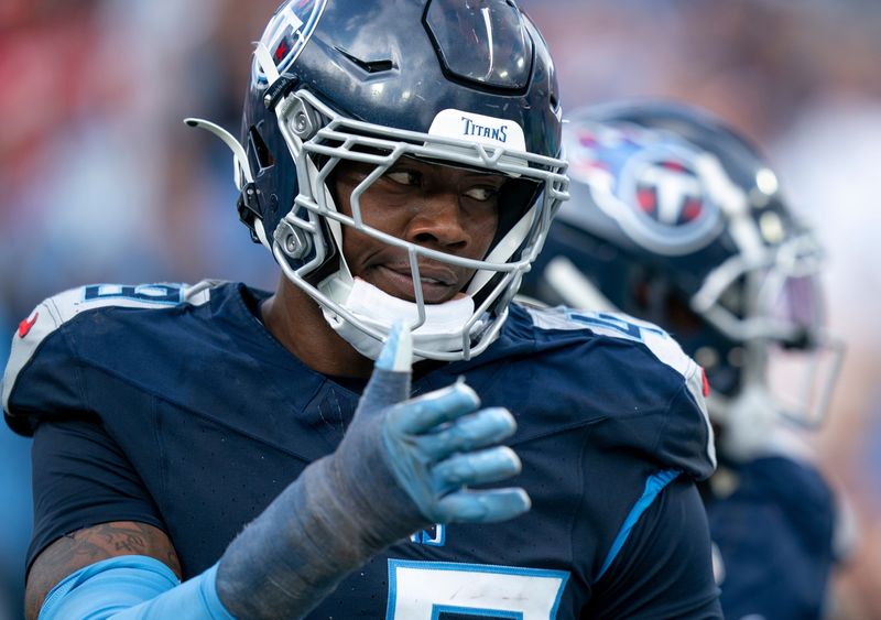 Tennessee Titans linebacker Arden Key (49) is congratulated after sacking New England Patriots quarterback Drake Maye (10) during their game at Nissan Stadium in Nashville, Tenn., Sunday, Nov. 3, 2024.