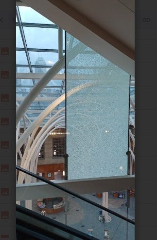 An interior glass panel shown here on March 11, 2026, at the Indianapolis Central Library branch, 40 E St Clair Street, fractured in February and required the library to close until further notice. The panel is 4’ wide x 12’ high and weighs approximately 575 pounds.