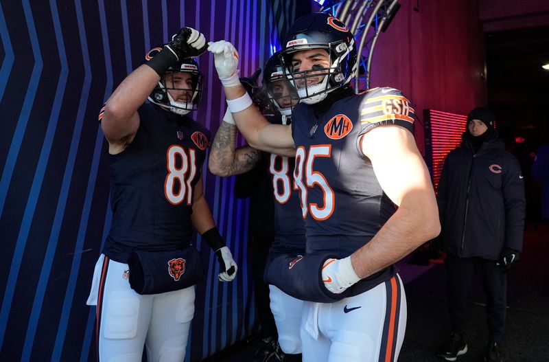 Dec 14, 2025; Chicago, Illinois, USA; Chicago Bears TE Durham Smythe (81) and Chicago Bears TE Cole Kmet (85) huddle before running onto the field for warmups prior to the game against the Cleveland Browns at Soldier Field. Mandatory Credit: David Banks-Imagn Images