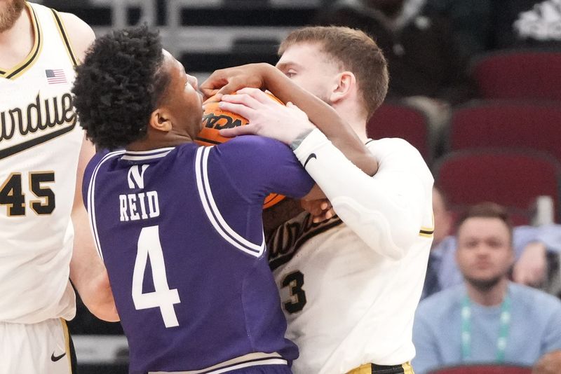 Mar 12, 2026; Chicago, IL, USA; Northwestern Wildcats guard Jayden Reid (4) and Purdue Boilermakers guard Braden Smith (3) grab the ball during the first half at United Center. Mandatory Credit: David Banks-Imagn Images