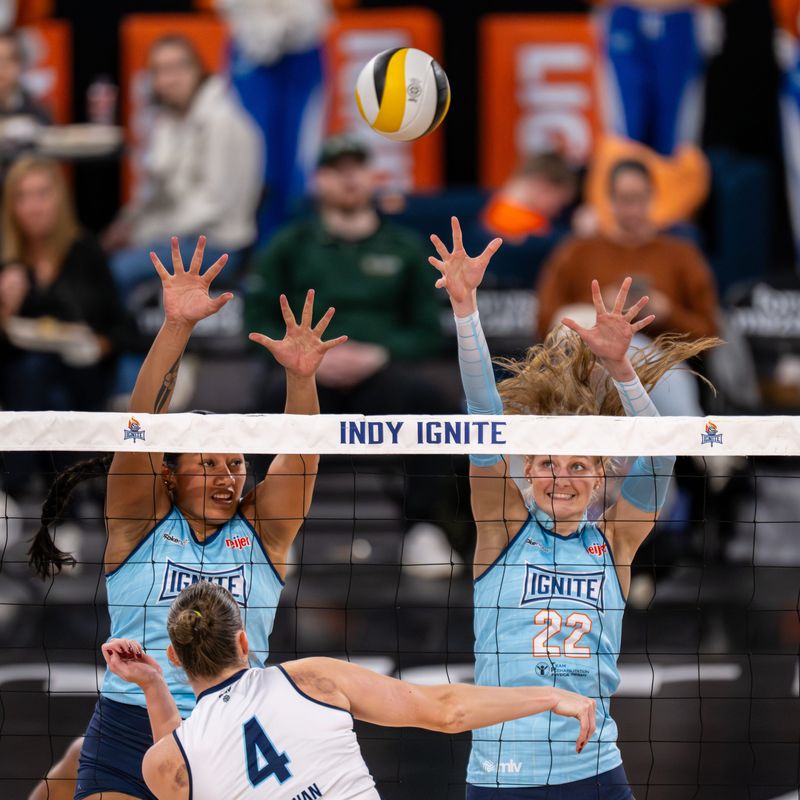Indy Ignite setter Mia Tuaniga, left, and Indy Ignite middle blocker Lydia Martyn (22) attempt to block a shot during a Major League Volleyball match against the Orlando Valkyries, Thursday, March 12, 2026, at Fishers Event Center.