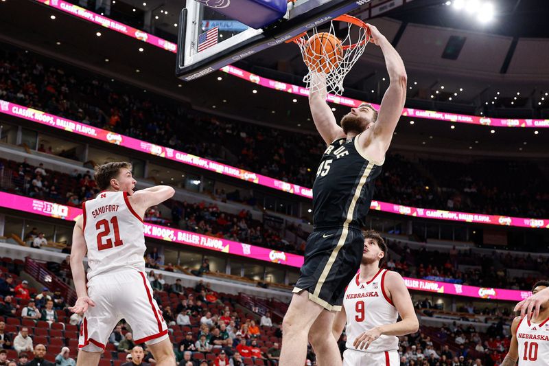 Mar 13, 2026; Chicago, IL, USA; Purdue Boilermakers center Oscar Cluff (45) scores against Nebraska Cornhuskers forward Pryce Sandfort (21) during the first half at United Center.