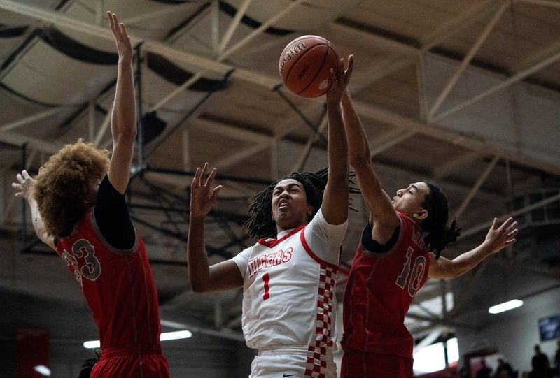 Princeton's Edwin Holmes (1) is blocked by Bosse’s Elijah Eastwood (10) as the Princeton Community Tigers play the Bosse Bulldogs during the 2026 IHSAA Class 3A Boys Basketball Regional game in Huntingburg, Ind., Saturday, March 14, 2026.