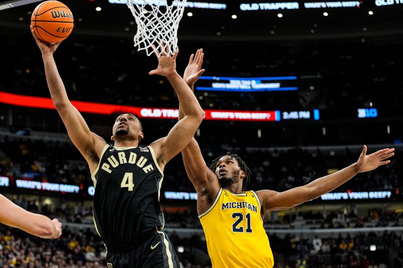 Purdue forward Trey Kaufman-Renn (4) goes to the basket against Michigan forward Morez Johnson Jr. (21) during the first half of Big Ten Tournament final at United Center in Chicago on Sunday, March 15, 2026.