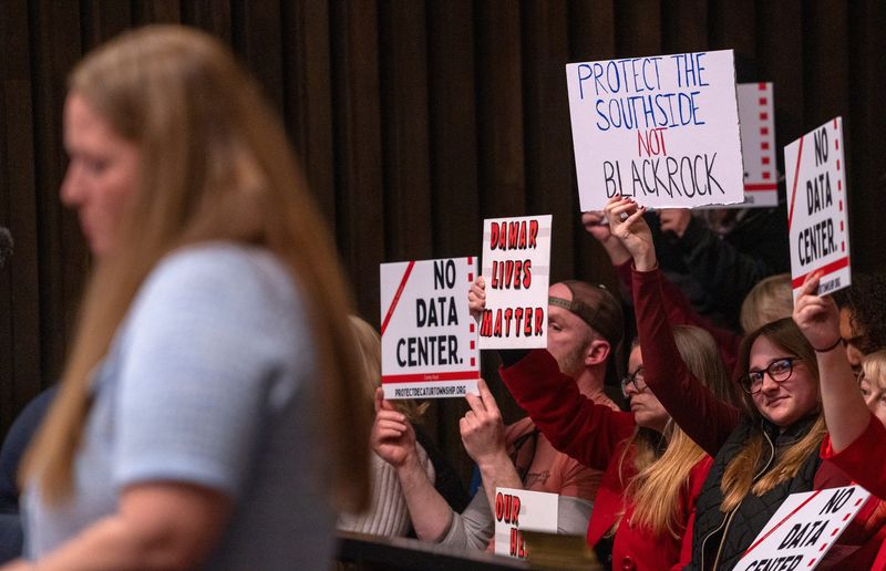 As people hold signs against the Sabey Data Center for Decatur Township, Mindy Westrick Brown, attorney for Sabey Data Center Properties, speaks during the Metropolitan Development Commission meeting to hear final testimony and vote on a petition Wednesday, March 18, 2026 that would allow Sabey to build a data center in Decatur Township at the corner of Kentucky Avenue and Camby Road. Sabey eventually won approval to build the center.