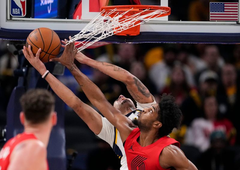 Portland Trail Blazers guard Scoot Henderson (00) blocks Indiana Pacers forward Jalen Slawson (18) on Wednesday, March 18, 2026, during the game at Gainbridge Fieldhouse in Indianapolis.