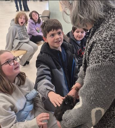 Jurnee McDonald, left, and Owen Livergood from Kingsford Heights Elementary School pet a chicken during the 2026 Ag Days at the LaPorte County Fairgrounds.