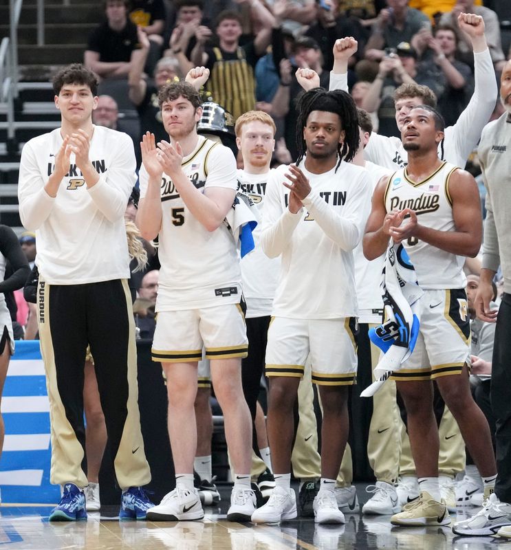 The Purdue Boilermakers bench applauds after guard Braden Smith (3) breaks the record in assists in the NCAA during a NCAA Tournament first round game against the Queens University of Charlotte Royals on Friday, March 20, 2026, at Enterprise Center in St. Louis.