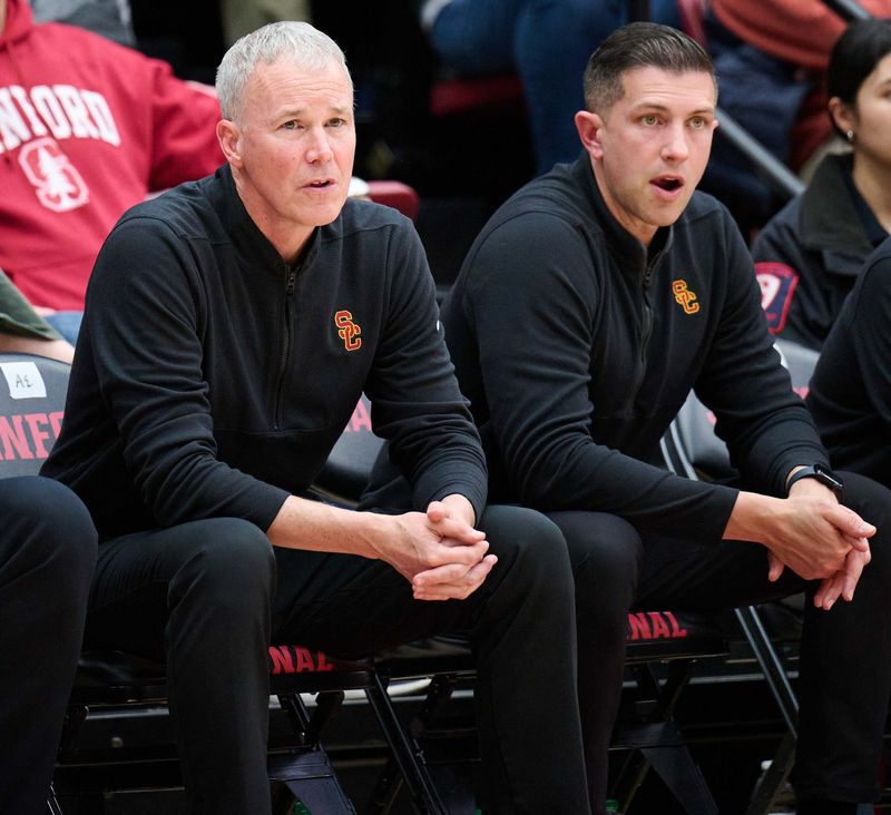 Chris Capko (right) sits next to former USC head coach Andy Enfield (left) during a game against Stanford at Maples Pavilion on Feb. 10, 2024. Capko was recently announced as the next head coach of Ball State basketball.