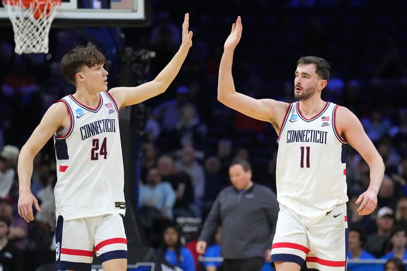 Mar 22, 2026; Philadelphia, PA, USA; UConn Huskies forward Alex Karaban (11) and guard Braylon Mullins (24) react in the second half during a second round game of the men's 2026 NCAA Tournament at Xfinity Mobile Arena.