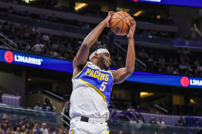 Mar 23, 2026; Orlando, Florida, USA; Indiana Pacers forward Jarace Walker (5) grabs the rebound during the first quarter against the Orlando Magic at Kia Center. Mandatory Credit: Mike Watters-Imagn Images