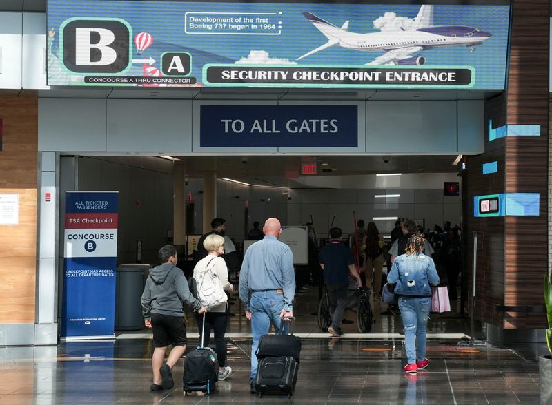 Travelers walk through the Indianapolis International Airport on Tuesday, March 24, 2026.