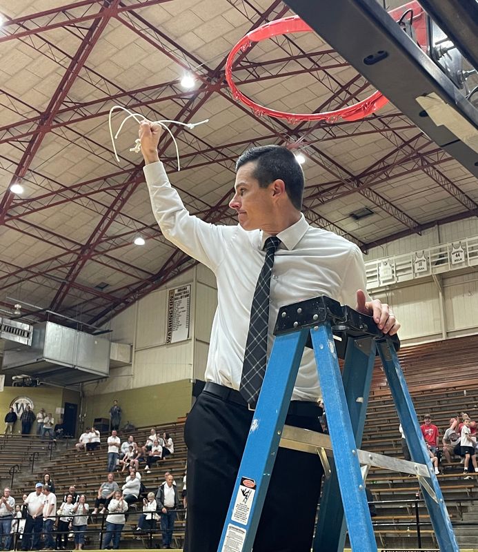Barr-Reeve coach Heath Howington cuts down the net following the Vikings’ 52-47 win over Hauser in the Class 1A semi-state at The Hatchet House.