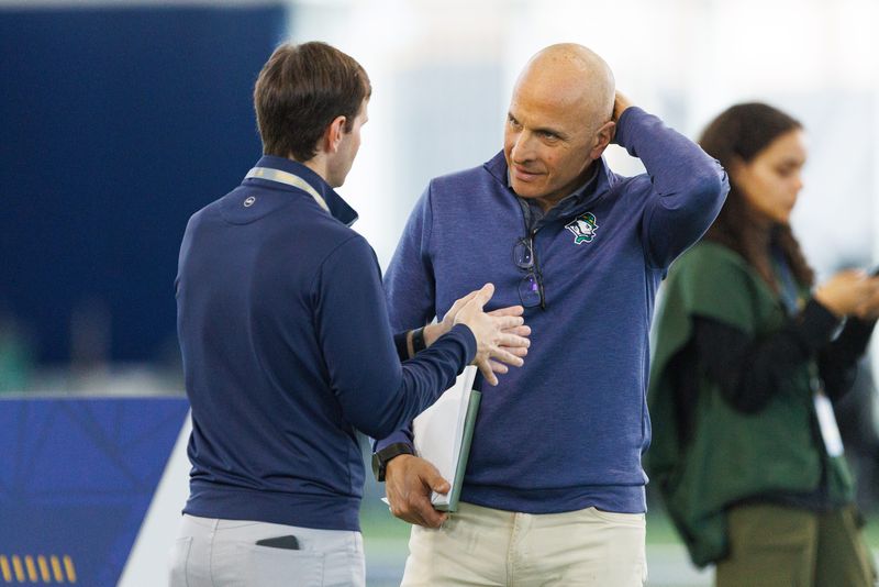 Notre Dame athletic director Pete Bevacqua, right, speaks with Clint Dowdle, agent for head coach Marcus Freeman, during Notre Dame football's Pro Day at Irish Athletic Center on Tuesday, March 24, 2026, in South Bend.