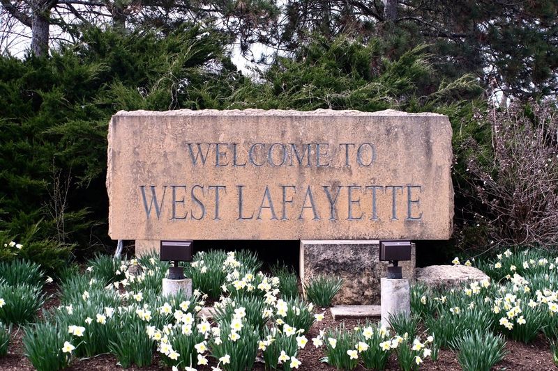 The sign ‘Welcome to West Lafayette” stands with white flowers in front on March 25, 2026, in West Lafayette, Indiana. File illustration.