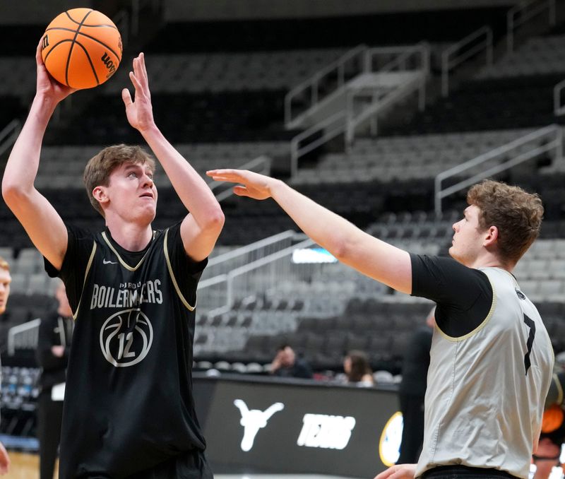 Purdue Boilermakers center Daniel Jacobsen (12) shoots the ball over forward Sam King (7) during practice ahead of a NCAA Tournament Sweet 16 game against the Texas Longhorns on Wednesday, March 25, 2026 at SAP Center in San Jose, Calif.