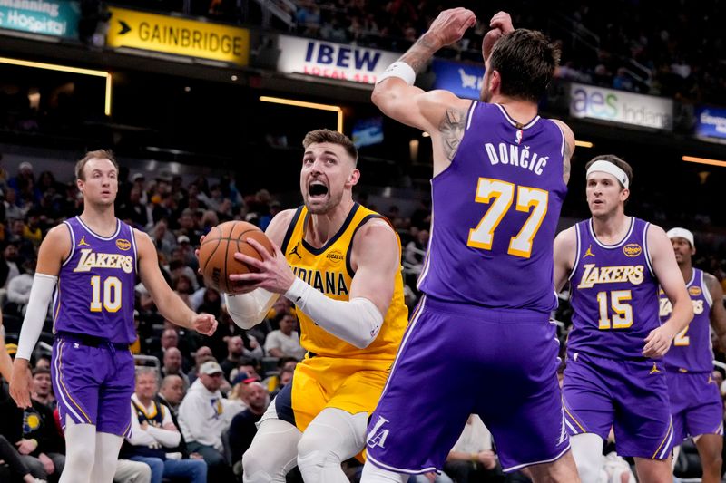 Indiana Pacers center Micah Potter (11) moves toward the basket in front of Los Angeles Lakers guard Luka Doncic (77) on Wednesday, March 25, 2026, during a game against the Los Angeles Lakers at Gainbridge Fieldhouse in Indianapolis.