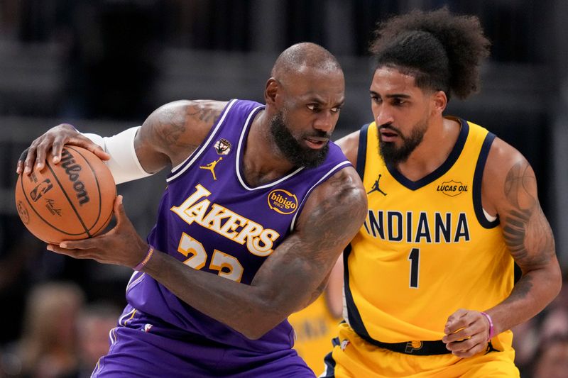 Los Angeles Lakers forward LeBron James (23) pushes his way up the court while being guarded by Indiana Pacers forward Obi Toppin (1) on Wednesday, March 25, 2026, during a game against the Los Angeles Lakers at Gainbridge Fieldhouse in Indianapolis.