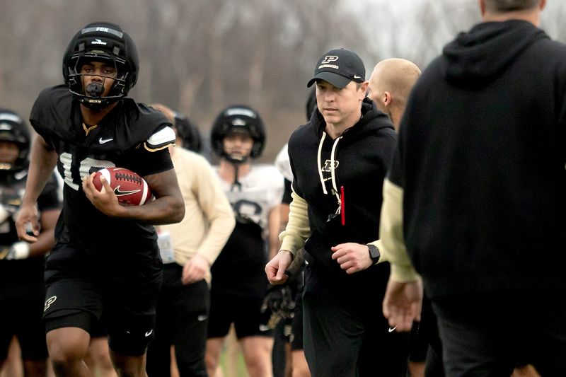 Purdue defensive coordinator Kevin Kane, right, runs during a drill with junior tight end Kylan Fox, left, during a drill on Tuesday, March 10, 2026, at Bimel Practice Complex in West Lafayette, Ind.