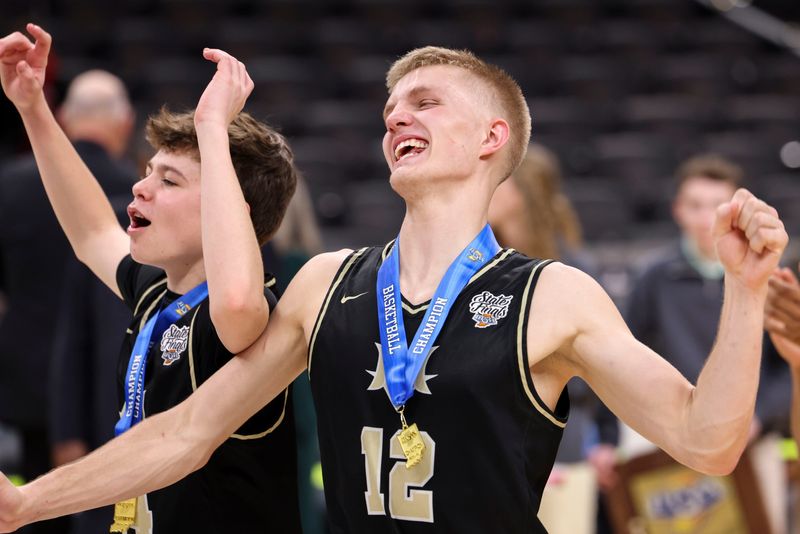 Mt. Vernon Marauders guard Owen Daugherty (14) and Mt. Vernon Marauders guard Luke Ertel (12) celebrate Saturday, March 28, 2026, during the Class 4A IHSAA boys state basketball championship game at Gainbridge Fieldhouse in Indianapolis. The Mt. Vernon Marauders defeated the Crown Point Bulldogs, 52-50.