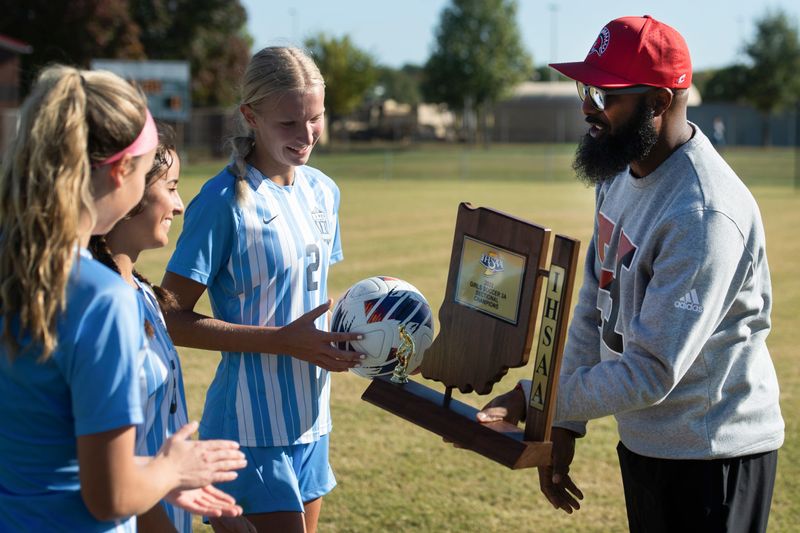 Harrison Athletic Director Andre Thomas presents Reitz Panthers players with the 3A Sectional Championship trophy after a victory over the Castle Knights At EVSC Soccer Complex in Evansville, Ind., Saturday afternoon, Oct. 8, 2022.